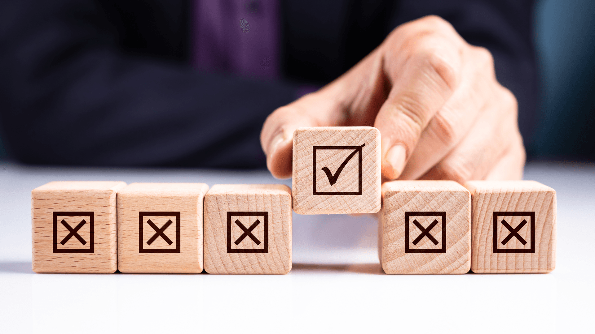 A hand flipping a wooden block from \