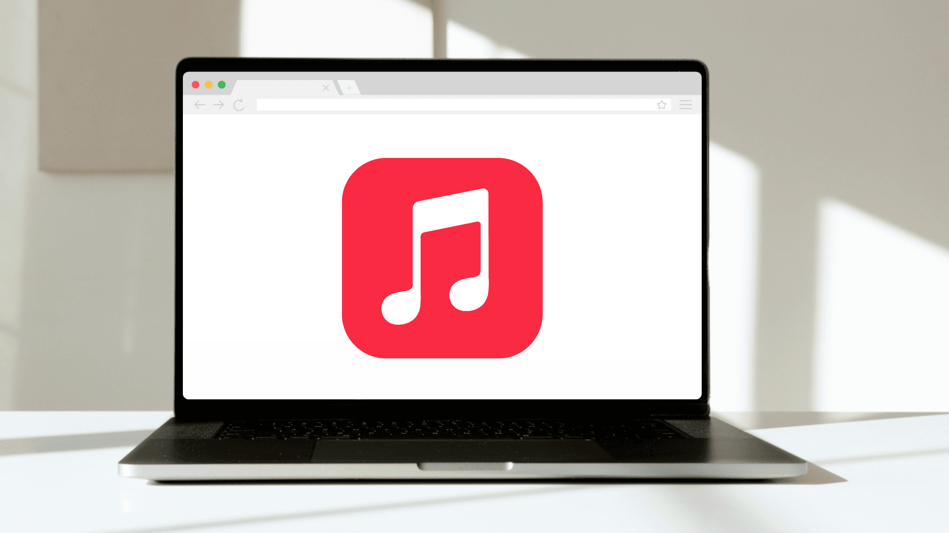 Laptop on a table displaying Apple Music browser player.