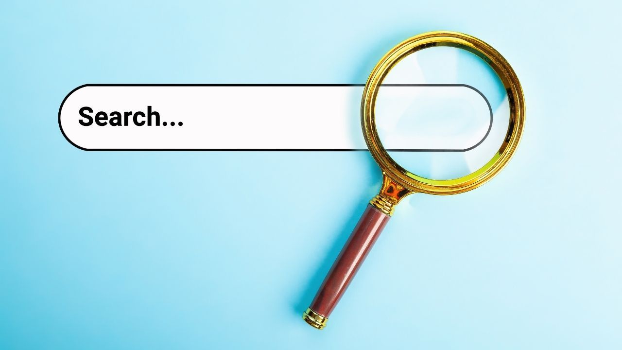 Magnifying glass over a search bar with a blue background, representing what is the address bar