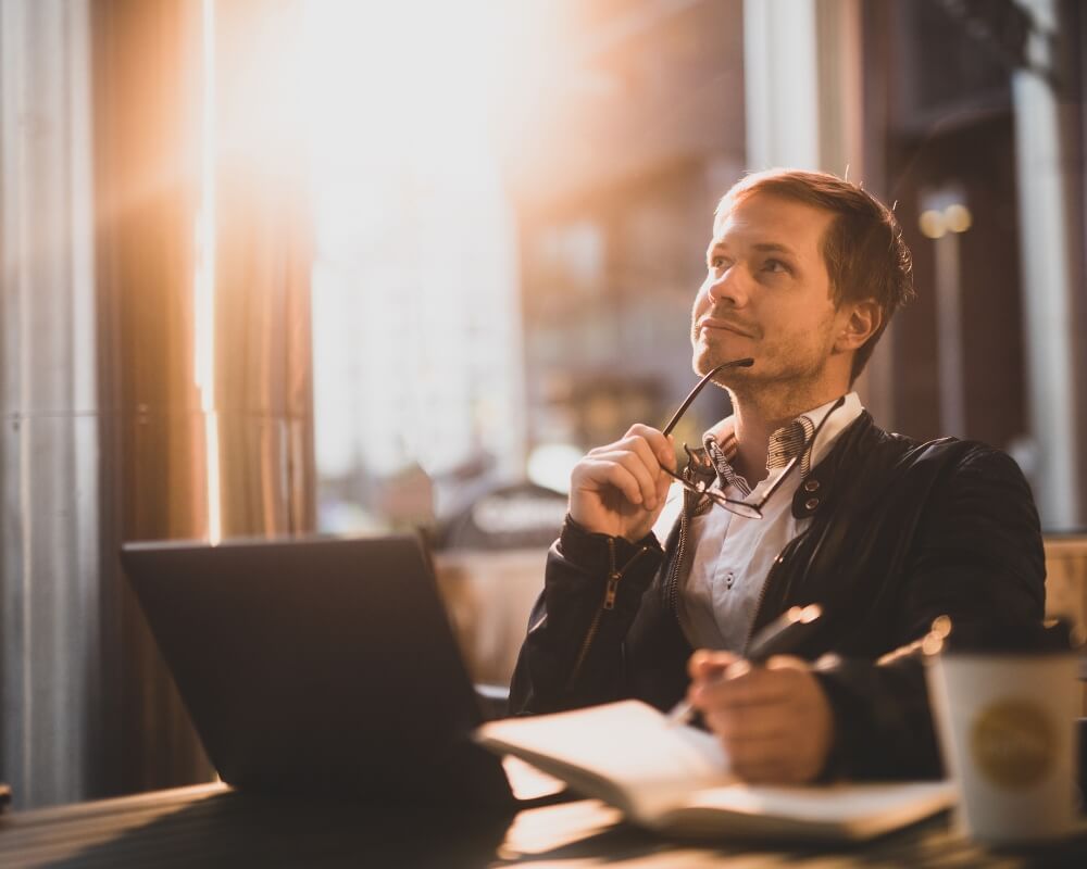 How to protect your online privacy using browser extensions image of person sitting in front of a laptop thinking