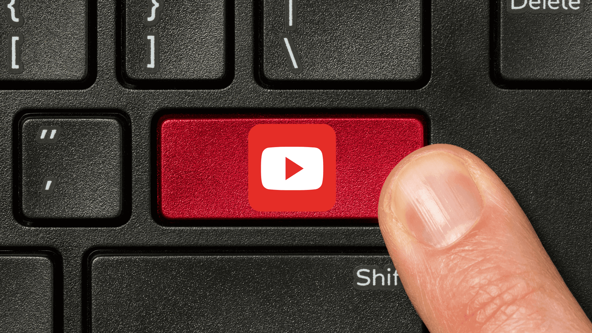 Red keyboard key with the YouTube logo on it, surrounded by black keys, representing YouTube shortcuts